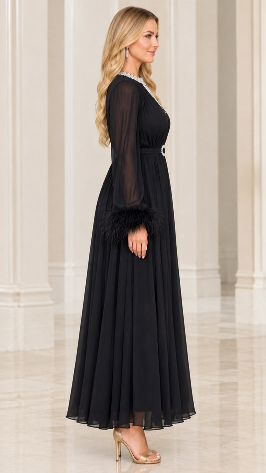 Side profile view of black long sleeve evening maxi dress with embellished belt