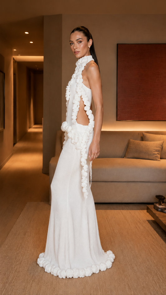 Side view of white asymmetrical evening gown with open side and cascading ruffle detail