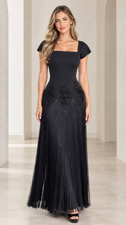Front view of black square neck cap sleeve evening dress with beaded waist and fringe maxi skirt