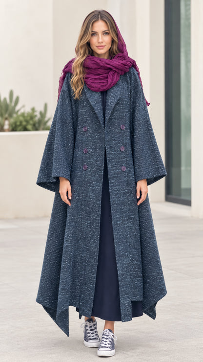 Front full-length view of woman wearing Slate Blue textured tweed maxi coat with flared handkerchief hem