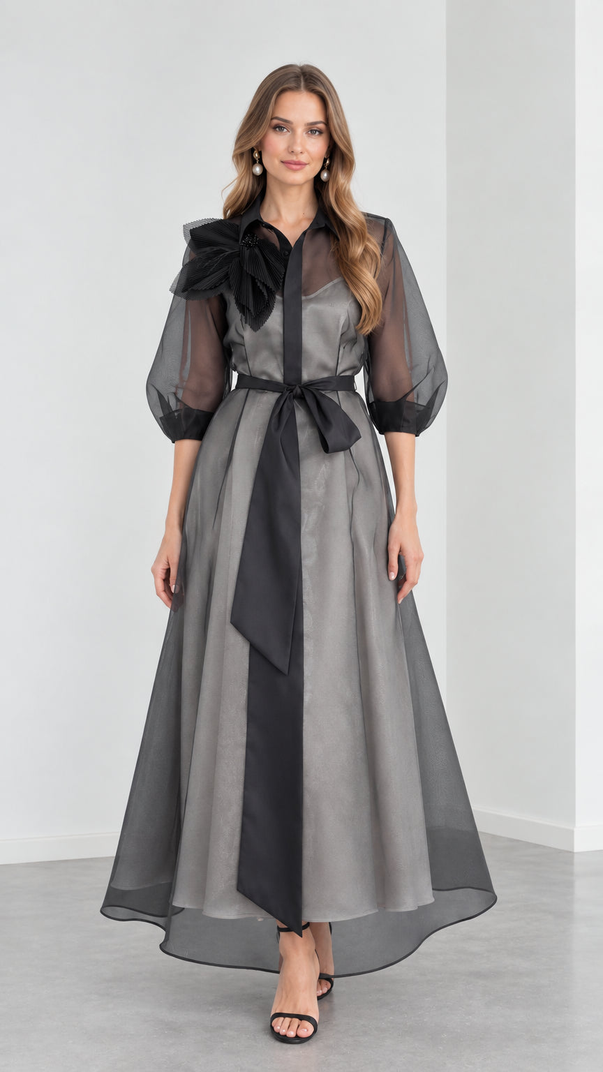 Full front view of model wearing Charcoal Grey organza collared maxi shirt dress with black sash and 3D floral shoulder detail