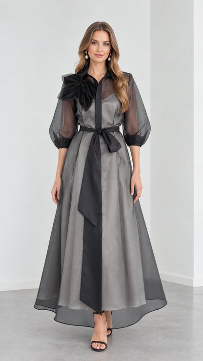 Full front view of model wearing Charcoal Grey organza collared maxi shirt dress with black sash and 3D floral shoulder detail