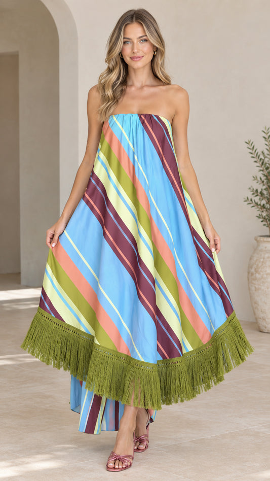 Front view of woman wearing sky blue multi striped strapless maxi dress with olive fringe hem