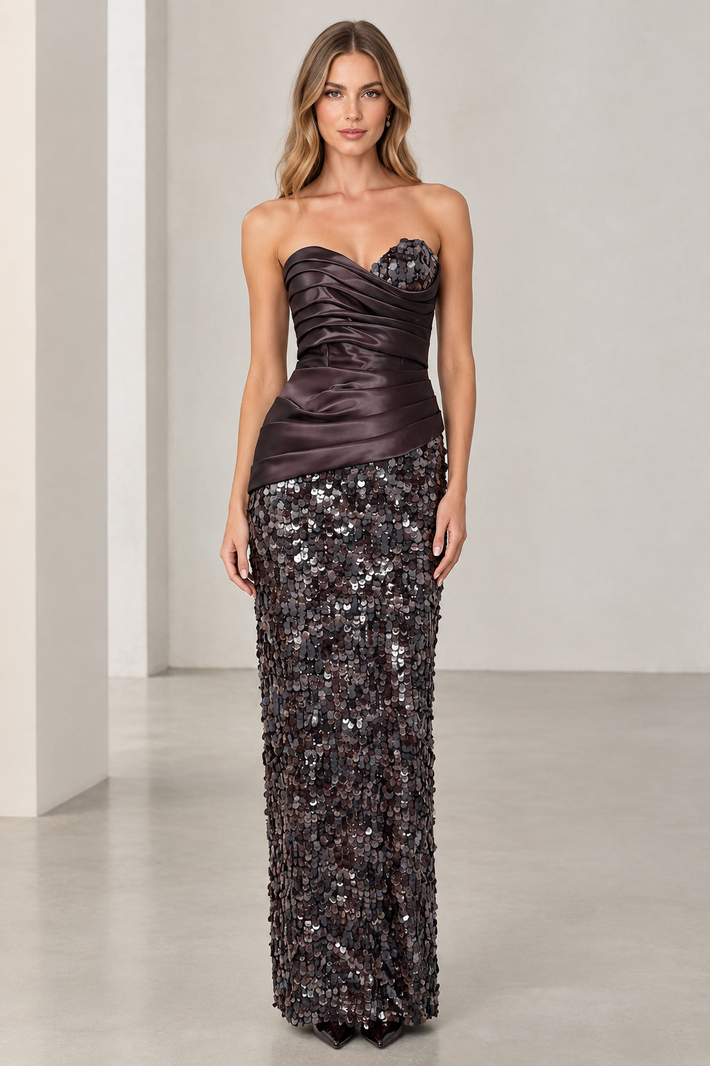 Front view of woman wearing strapless espresso brown satin and sequin column gown