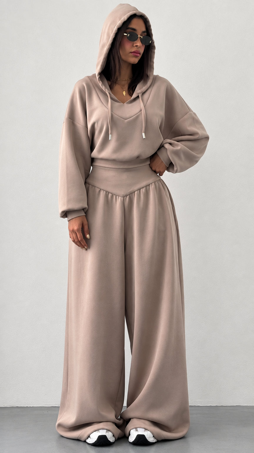 Front view of woman wearing taupe hooded sweatshirt and wide leg sweatpants lounge set