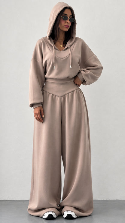 Front view of woman wearing taupe hooded sweatshirt and wide leg sweatpants lounge set