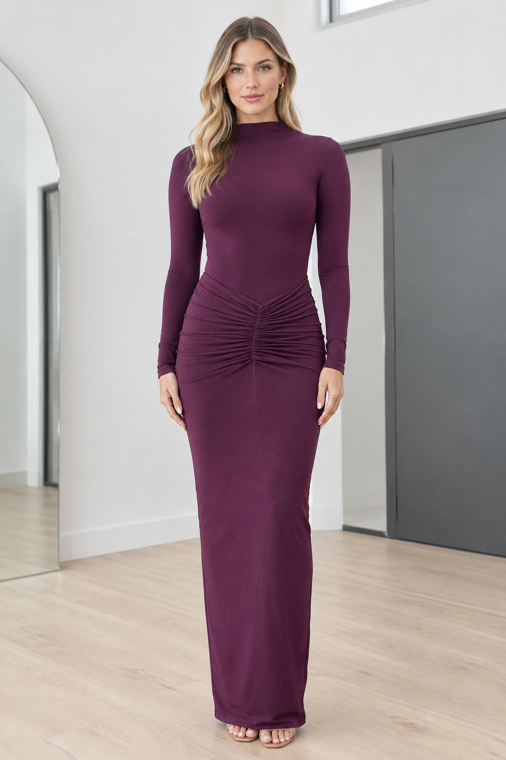 Full front view of model wearing Plum mock neck long sleeve ruched maxi dress