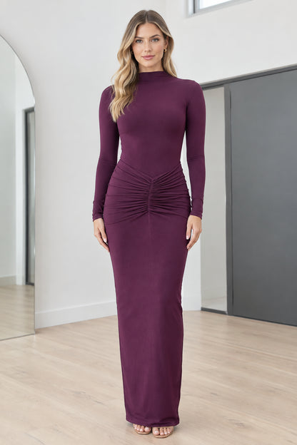 Full front view of model wearing Plum mock neck long sleeve ruched maxi dress