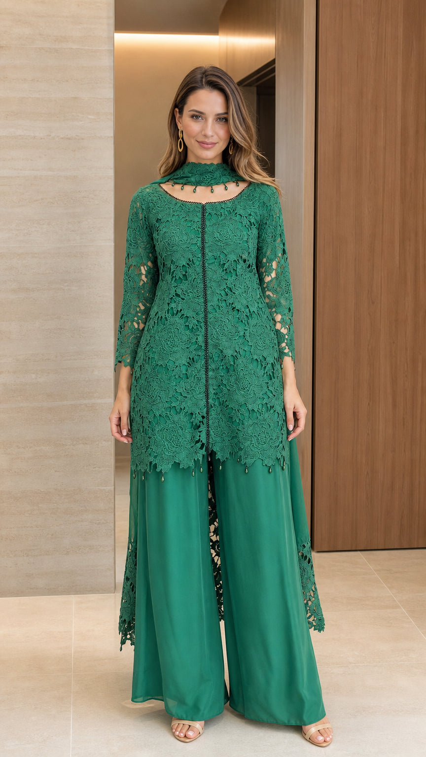 Front full-length view of woman wearing emerald green floral lace tunic and wide-leg pant set