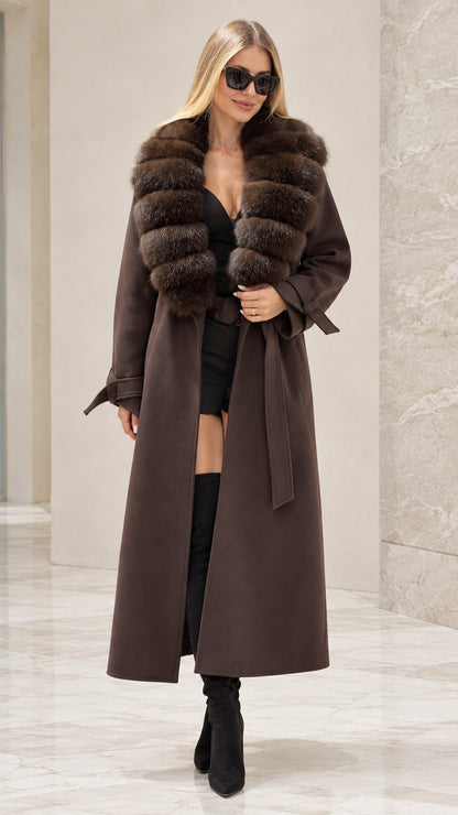 Front full view of woman wearing brown maxi trench coat with faux fur collar and belt