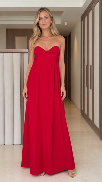 Front full view of woman wearing vibrant red strapless sweetheart maxi dress with bow detail