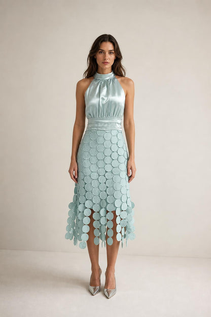 Front view of sage green satin halter neck midi dress with circle fringe hem