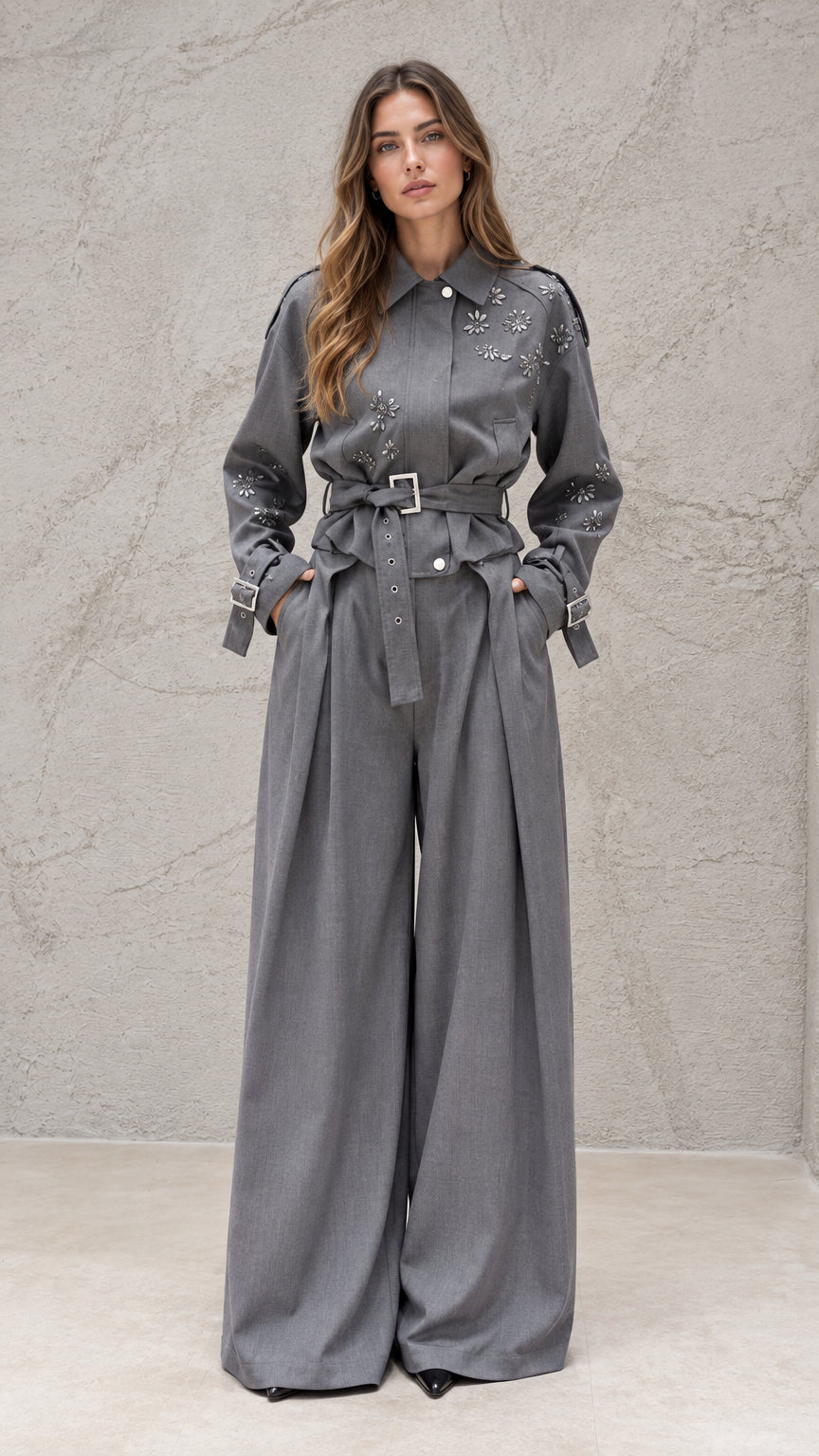 Full front view of model wearing grey embellished belted wide-leg jumpsuit
