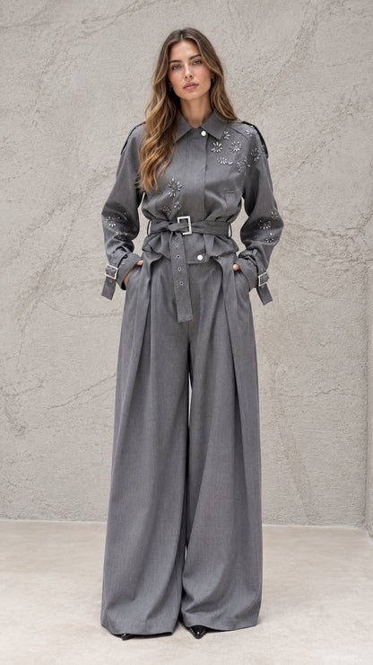 Full front view of model wearing grey embellished belted wide-leg jumpsuit