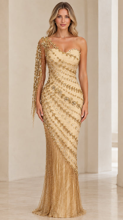 Front view of model wearing Champagne Gold one-shoulder beaded evening gown with fringe sleeve
