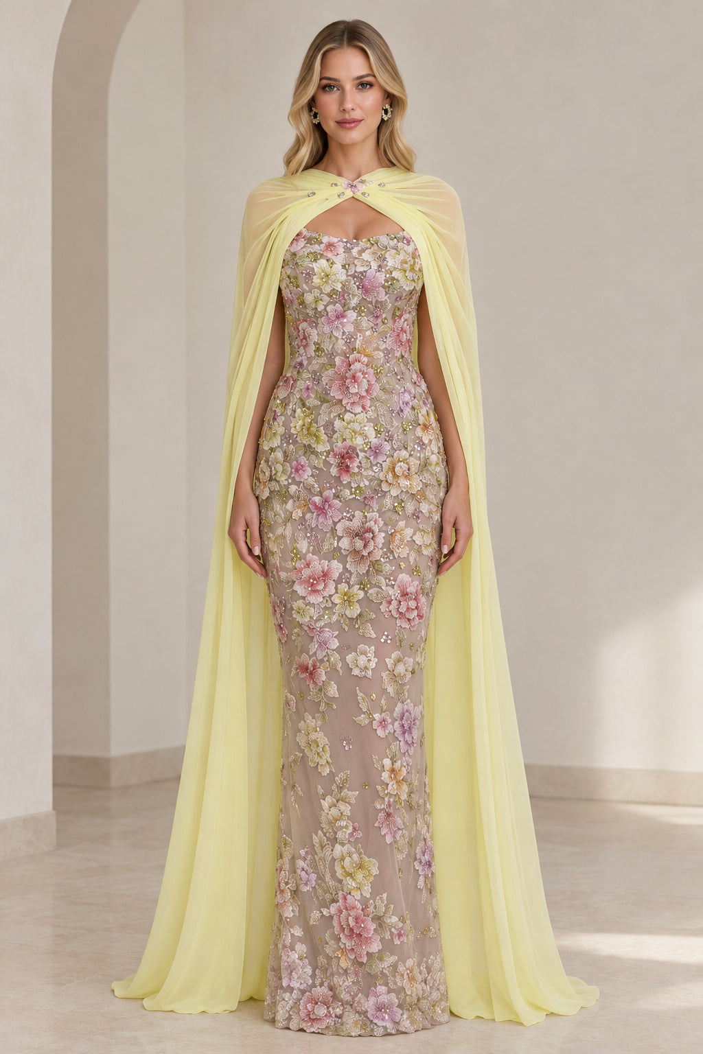 Front view of model wearing Pastel Yellow floral embroidered evening gown with matching chiffon cape