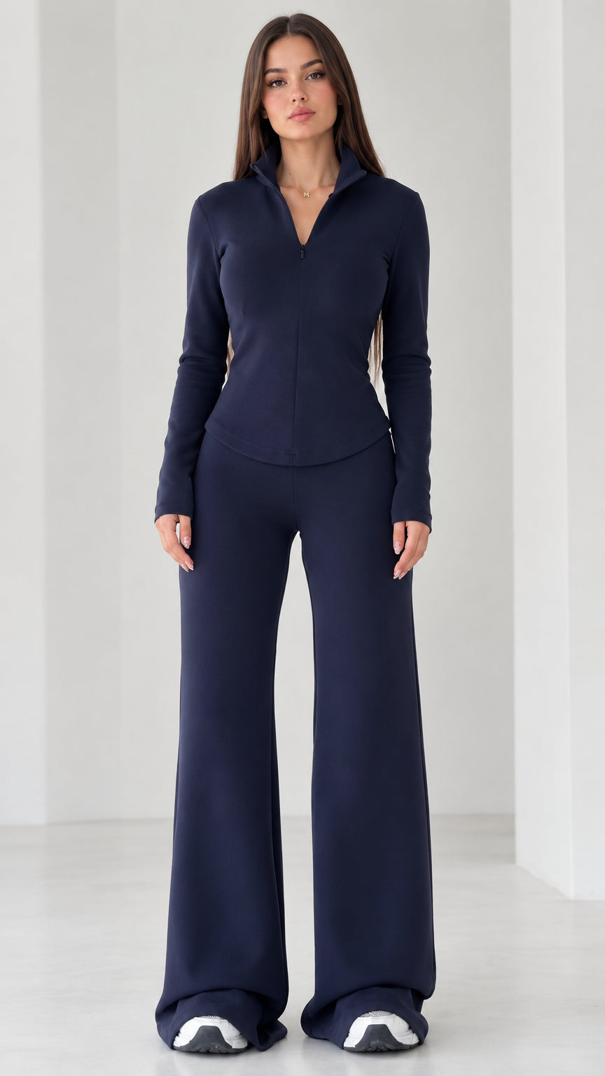 Full front view of women's navy blue quarter-zip top and wide-leg flare pants set