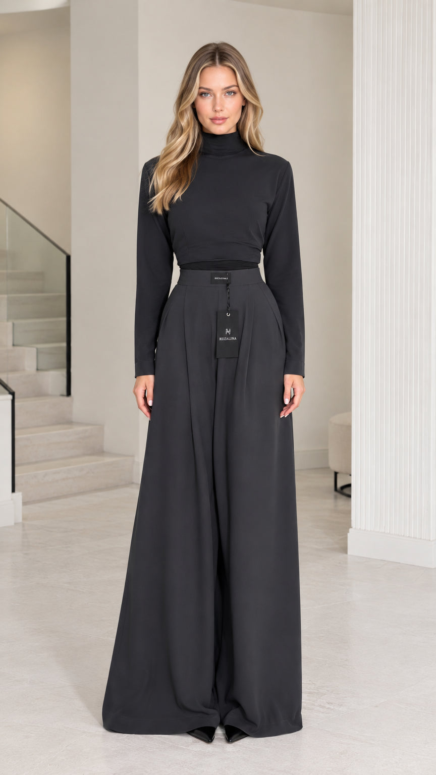 Full front view of model wearing black mock neck top and wide leg palazzo pants set