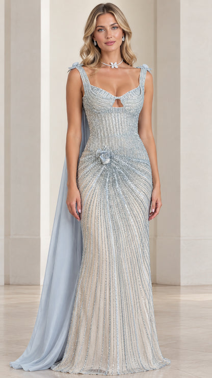 Front view of model wearing ice blue beaded evening gown with cape train
