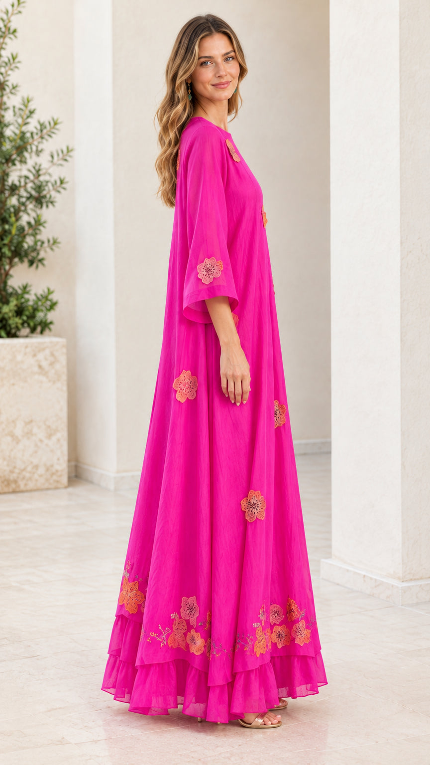 Side profile of fuchsia flowing maxi dress with 3/4 flared sleeves