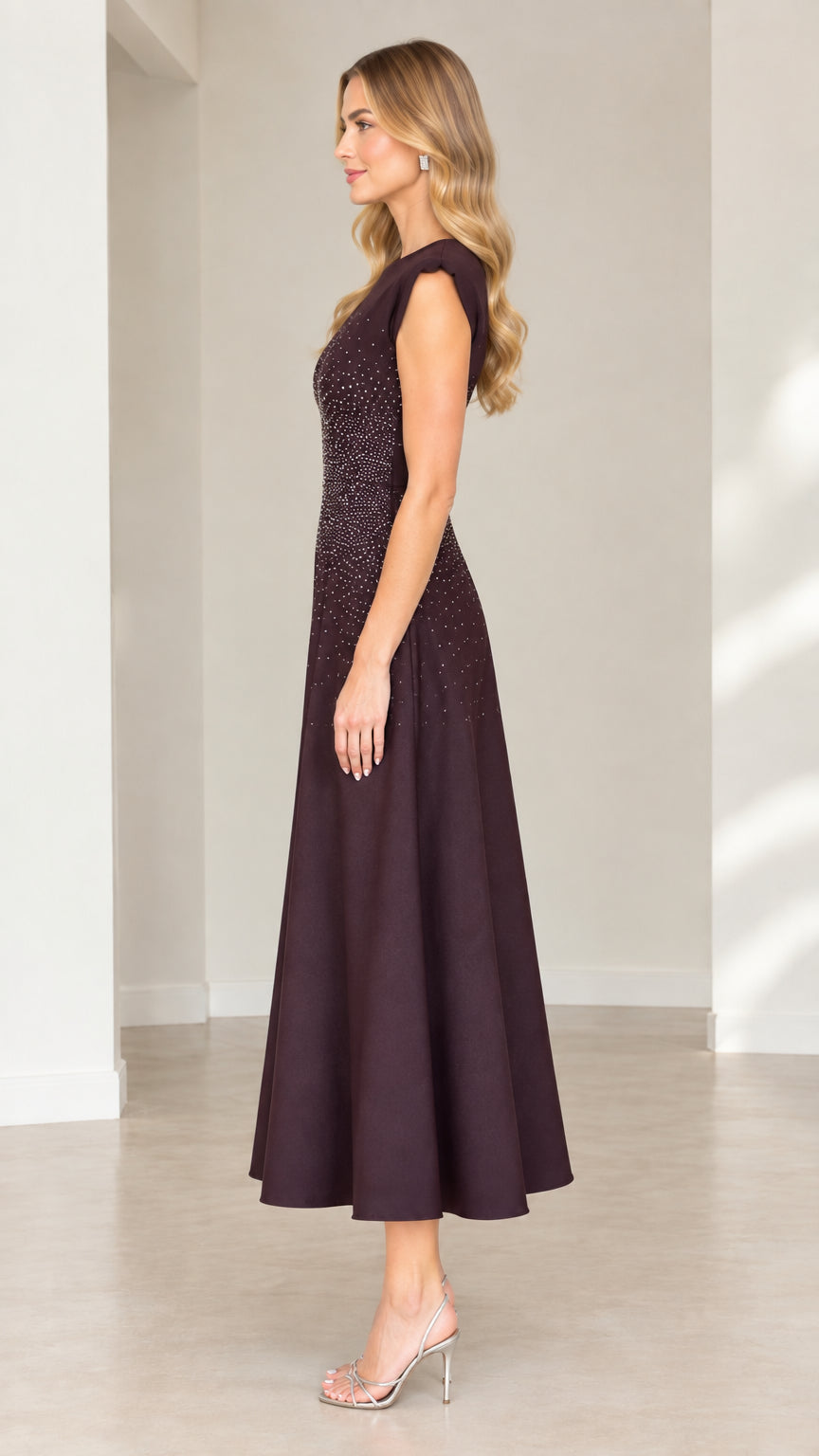 Side profile view of plum rhinestone embellished fit and flare midi dress