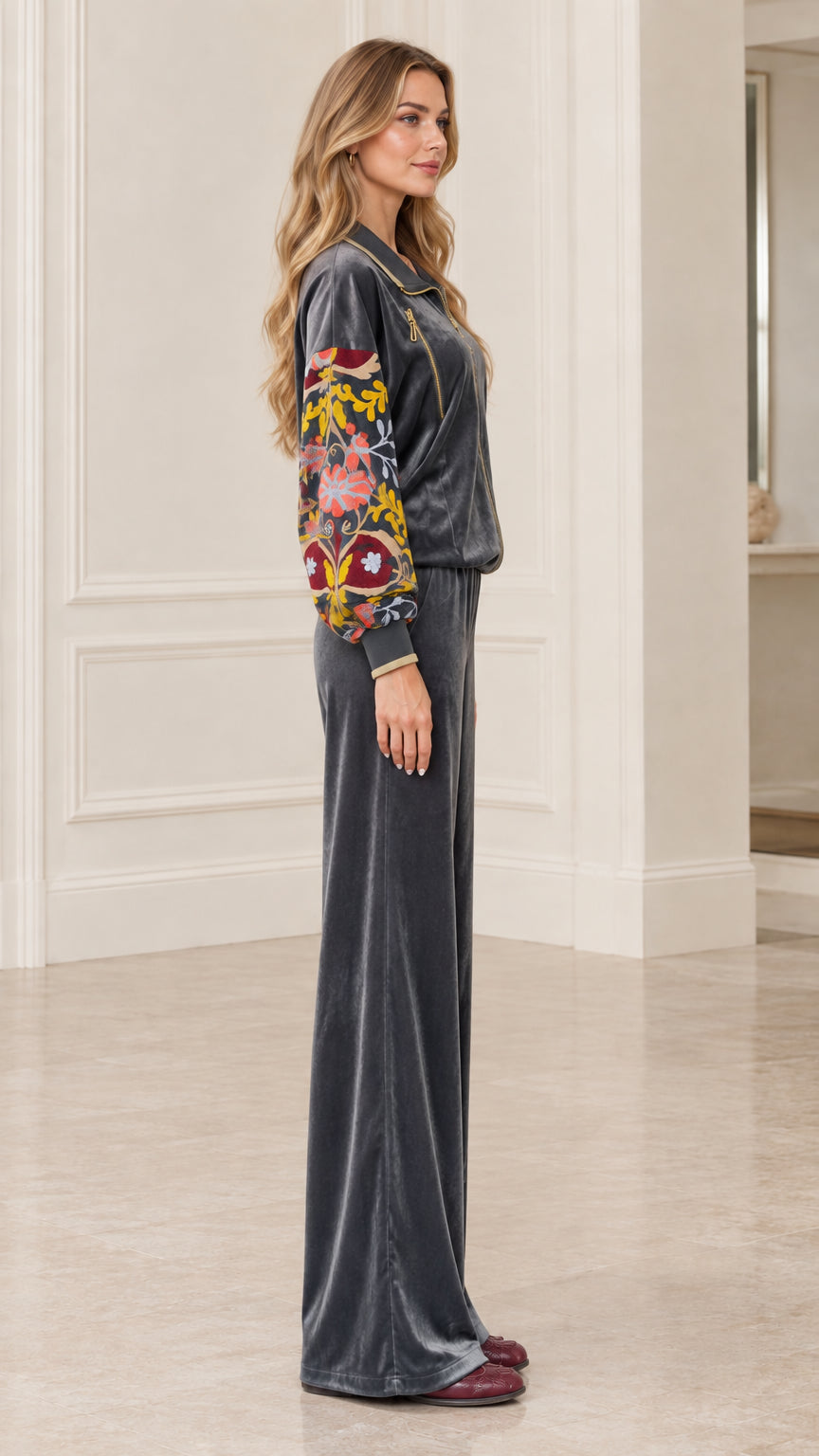 Side profile of women's charcoal velvet zip jacket and wide-leg pants