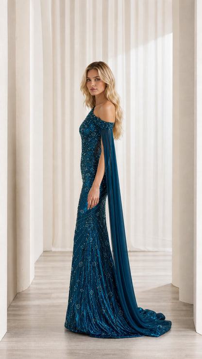 Side profile of woman wearing teal blue sequin gown showing long chiffon cape train