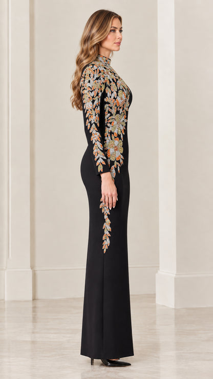 Side profile view of black long sleeve formal gown showing embroidered sleeve and hip detail
