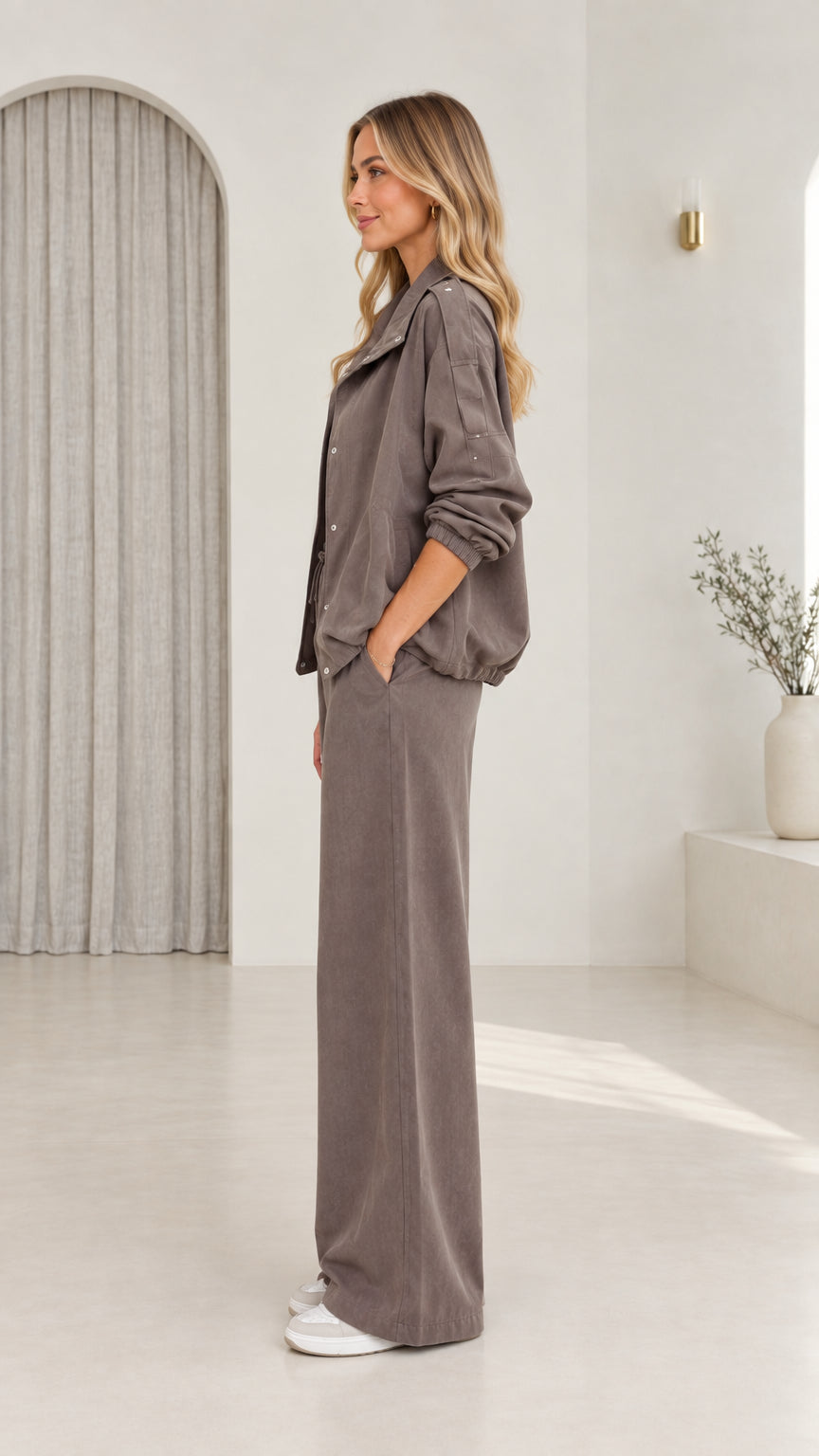 Side profile view of model in taupe casual two-piece pant set