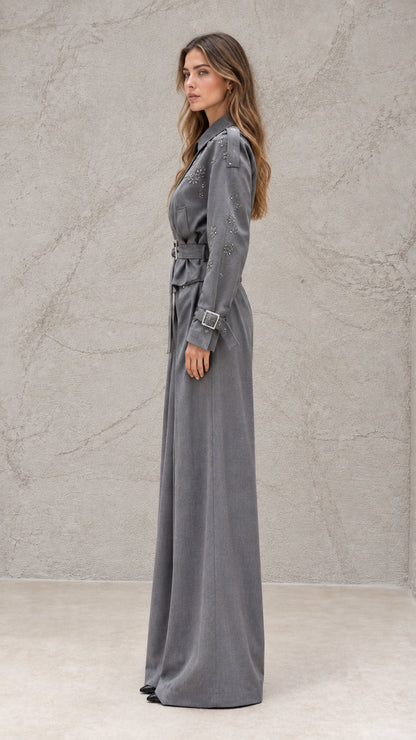 Side profile view of grey long sleeve wide-leg jumpsuit with buckled belt