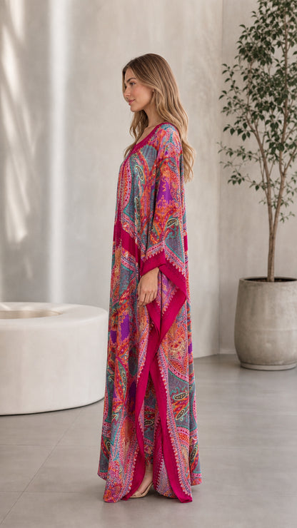 Side view of model wearing flowing Fuchsia bohemian caftan dress