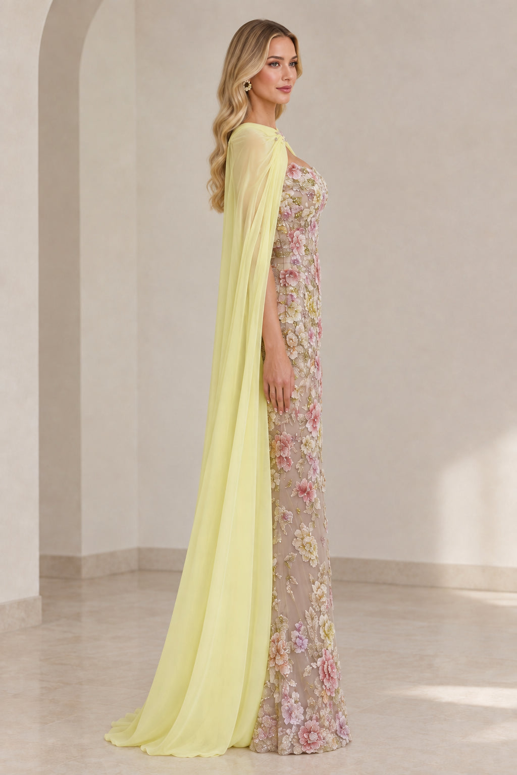 Side profile view of Pastel Yellow embroidered evening dress and long flowing cape
