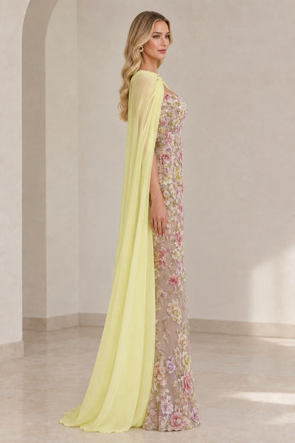 Side profile view of Pastel Yellow embroidered evening dress and long flowing cape
