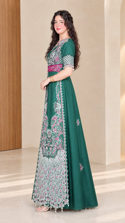 Side full view of woman wearing emerald green embroidered formal maxi dress