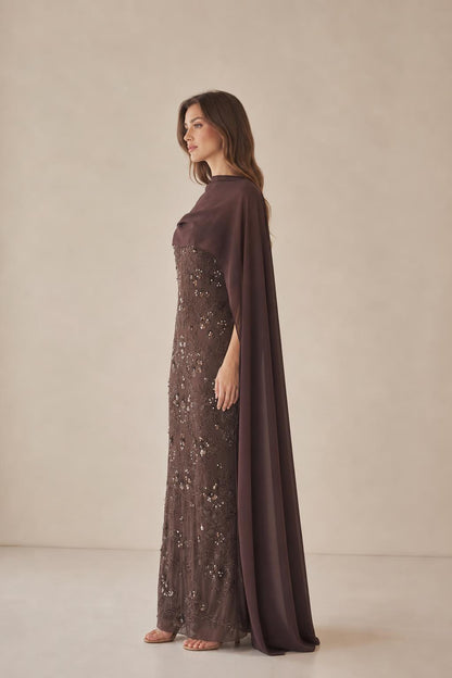 Side profile of model in brown cape evening gown