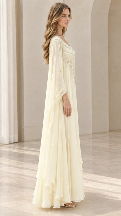 Side profile of cream flowy kaftan gown with draped cape sleeves