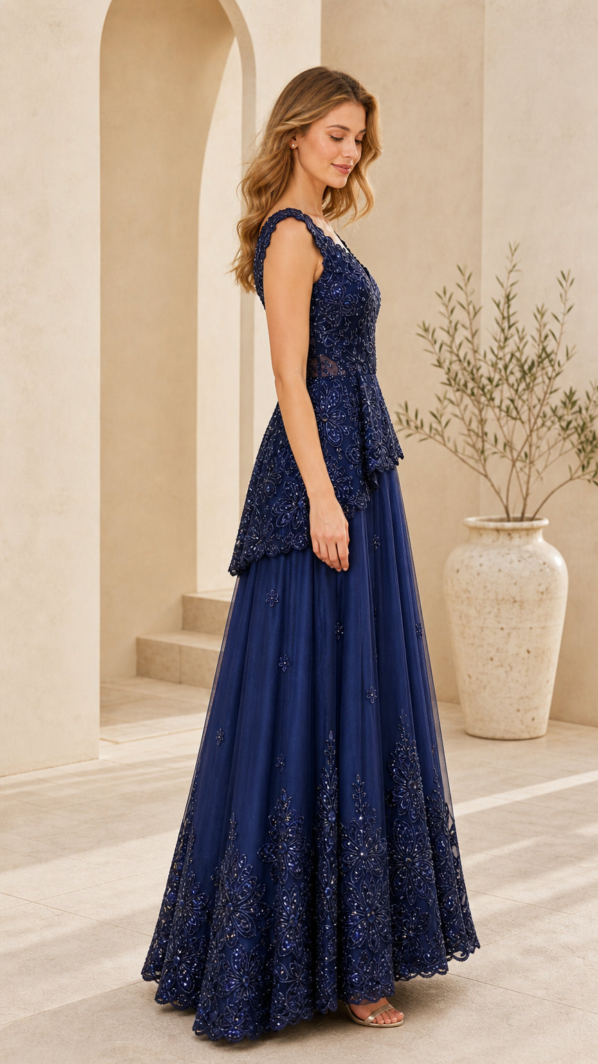 Side angle of model posing in Navy Blue beaded lace formal gown
