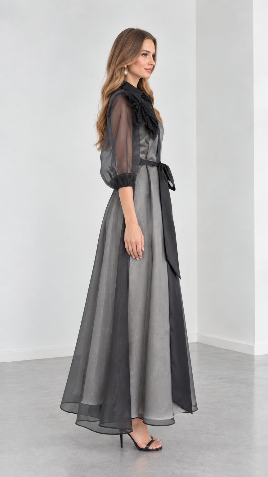 Side profile view of Charcoal Grey organza evening gown with sheer puff sleeves