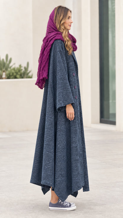 Side profile view of woman modeling Slate Blue asymmetric longline coat