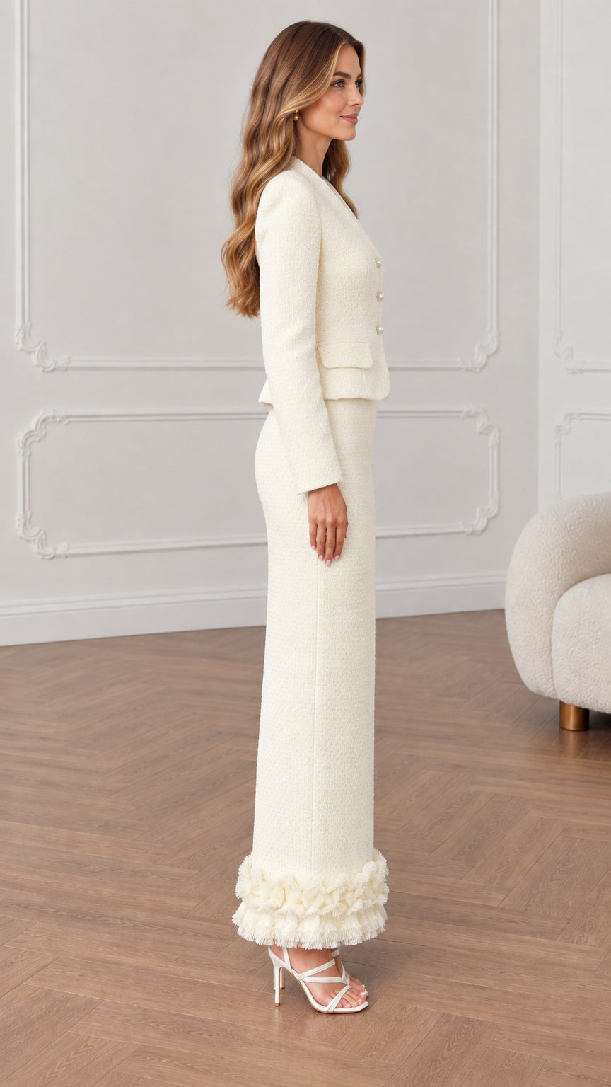 Side profile view of cream tailored tweed jacket and column maxi skirt