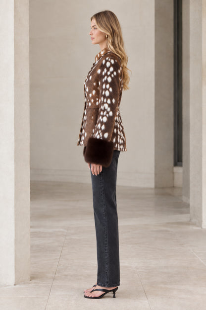 Side profile view of model wearing brown spotted faux fur button jacket