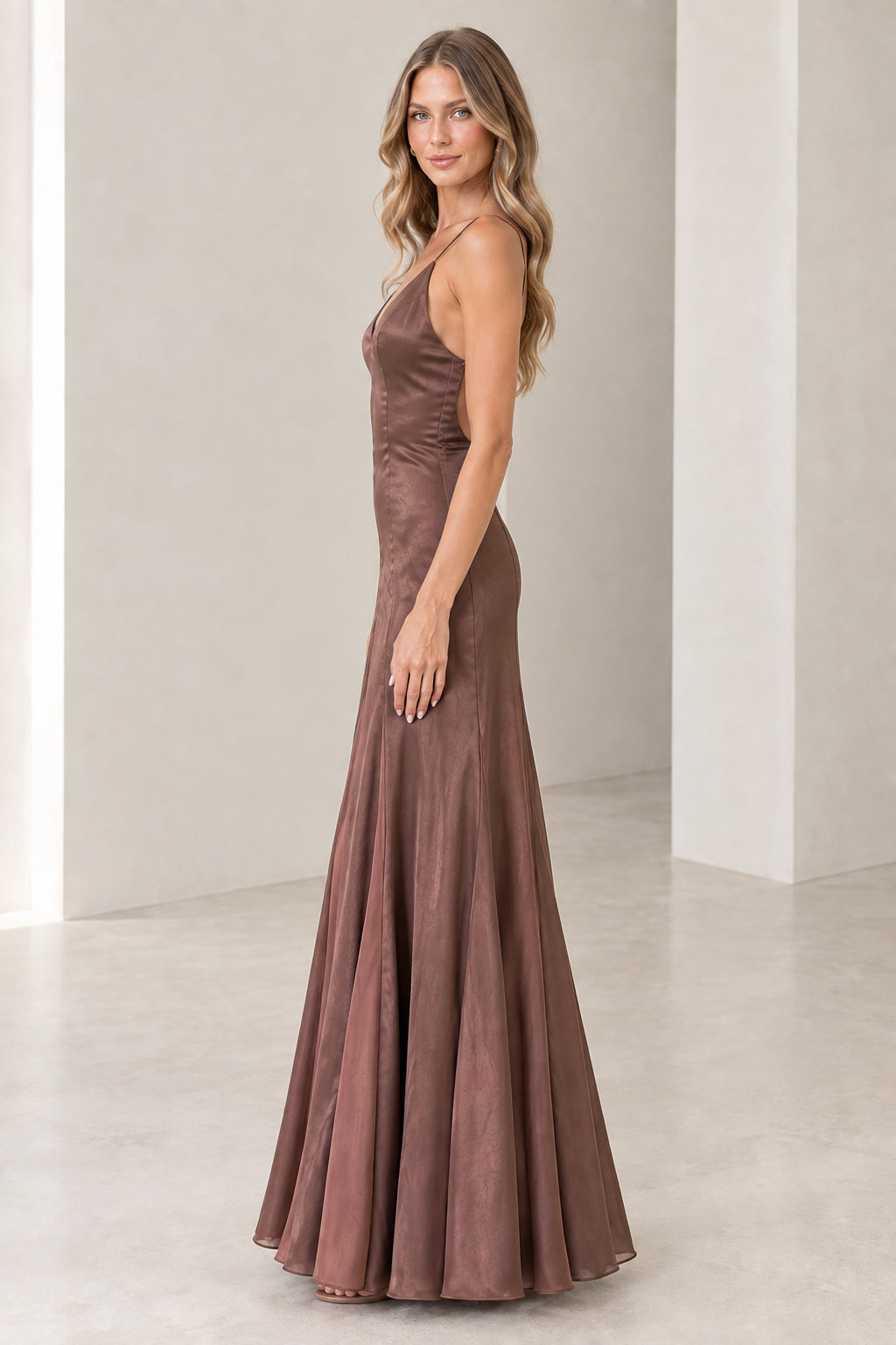 Side profile view of model wearing Mocha Brown flared satin maxi gown
