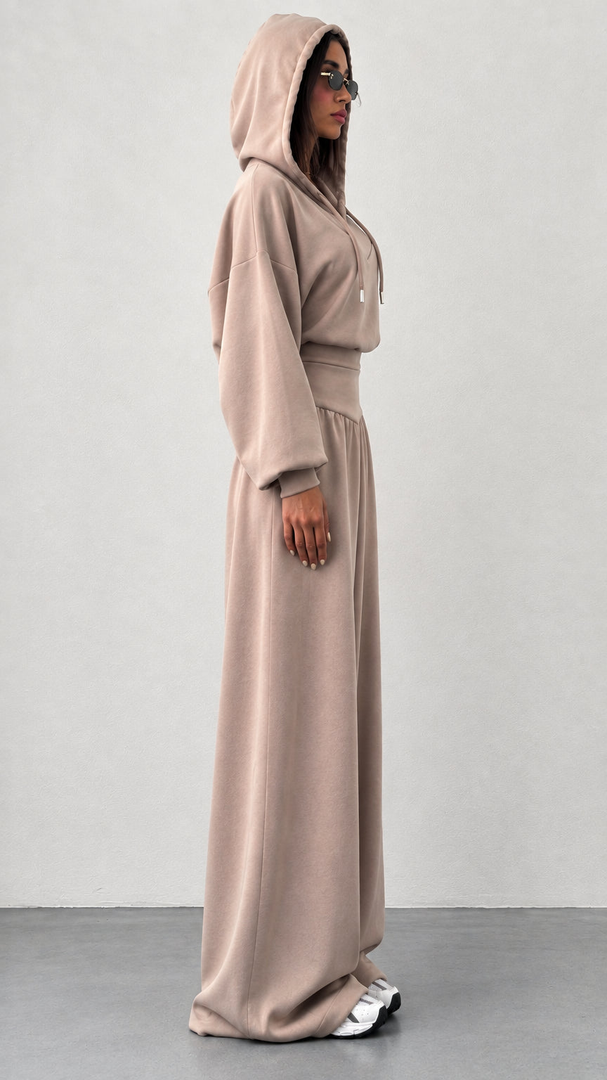 Side profile of woman wearing taupe wide leg two piece loungewear set