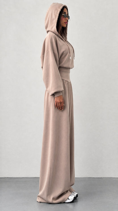 Side profile of woman wearing taupe wide leg two piece loungewear set