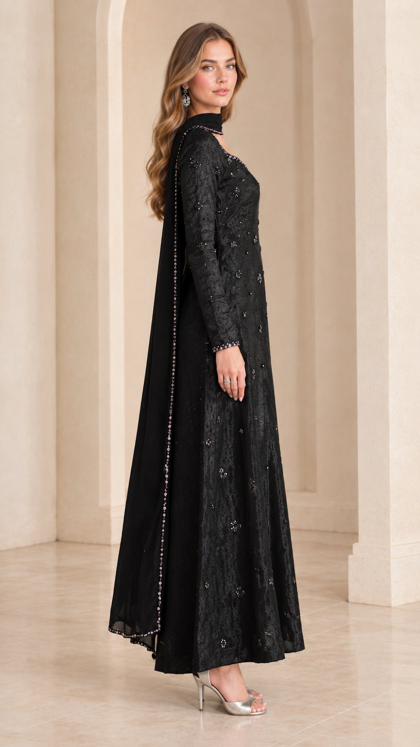Side profile view of black beaded long sleeve flared maxi gown