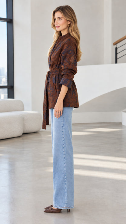Side profile of model wearing rust brown jacquard jacket with tie belt