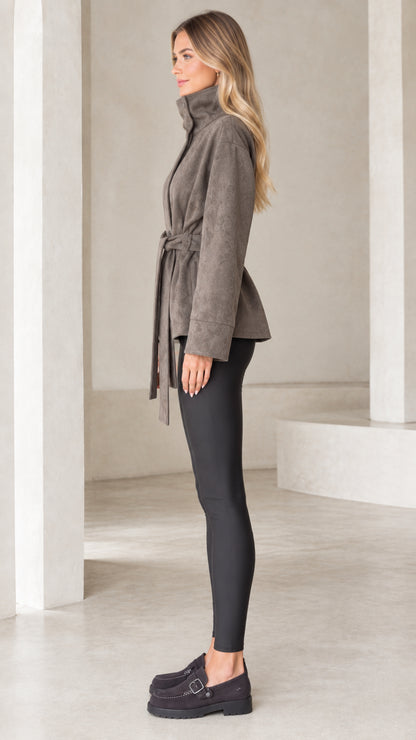 Side profile of model wearing taupe high-neck belted short wrap jacket