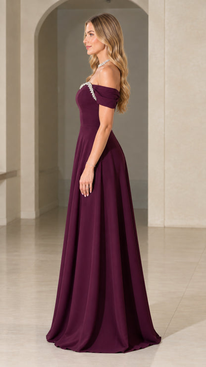 Side profile view of burgundy off-the-shoulder A-line formal maxi dress