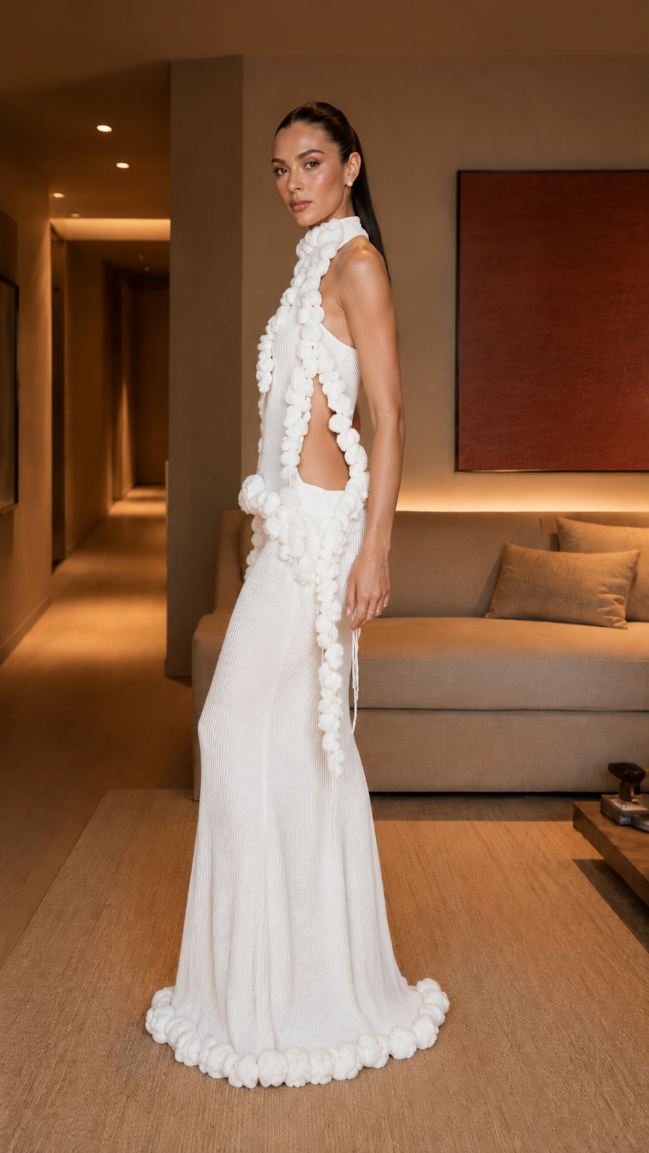 Side view of white asymmetrical evening gown with open side and cascading ruffle detail
