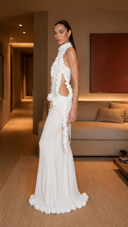 Side view of white asymmetrical evening gown with open side and cascading ruffle detail